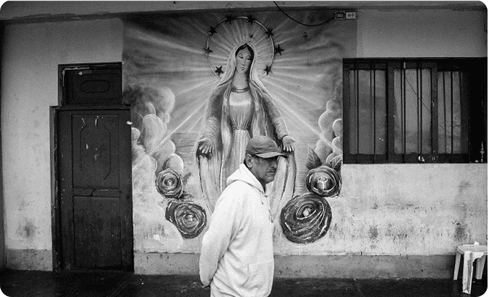 Man in front of Madonna mural
