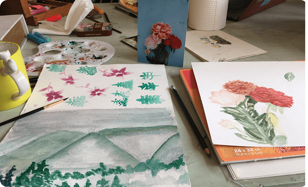 Watercolor paintings on a desk